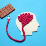 Figure of man and bar of sweet chocolate. Nutrition brain energy